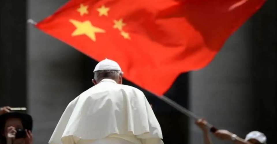 A worshiper waves the flag of China as Pope Francis leaves following a weekly general audience on June 12, 2019, in St. Peter’s Square at the Vatican. 