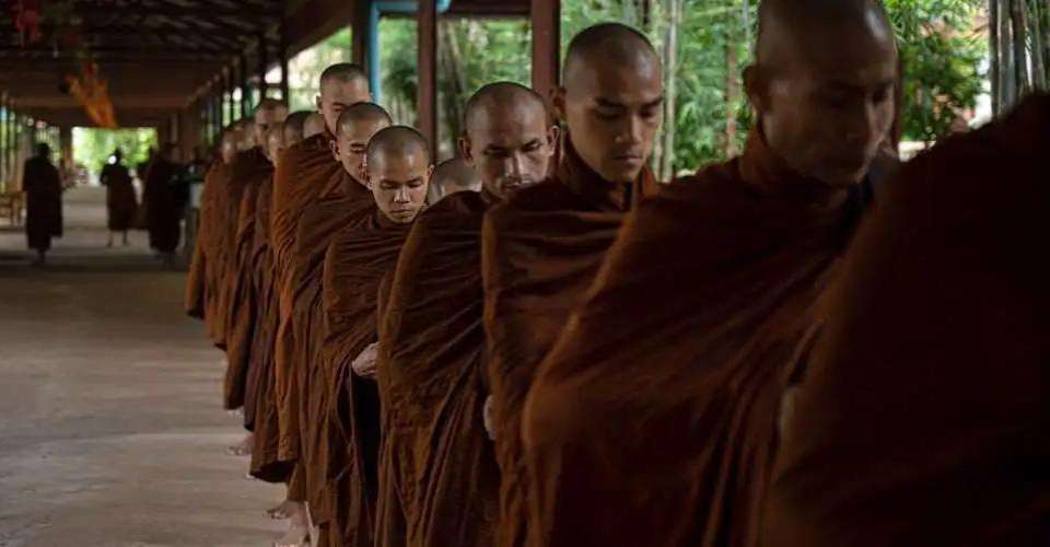 Buddhist novice monks line up for lunch alms at a monastery in Yangon in this July 13, 2023 photo. A second monk has reportedly been shot dead in Myanmar’s Mandalay region in the space of three days.
