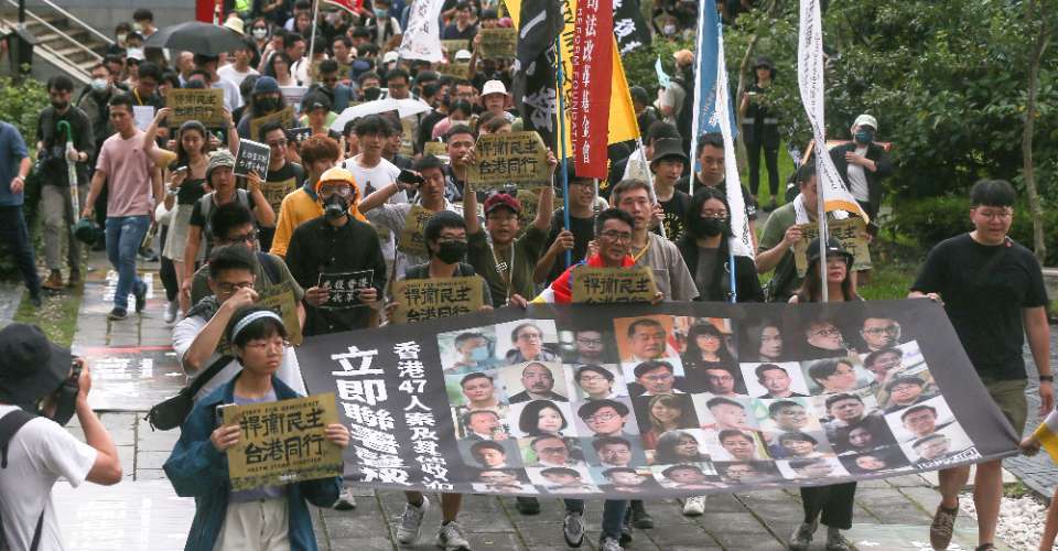 Hongkongers living in Taiwan and members of local civic groups march with a banner bearing the images of 47 of Hong Kong’s most prominent pro-democracy figures during a rally in Taipei on June 9 to mark the fifth anniversary of the start of Hong Kong's 2019-2020 mass protests.